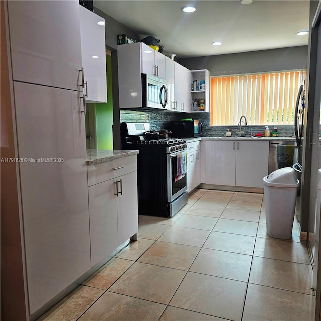 12900 SW 81st St, Kendall, FL 33183 - kitchen with appliances with stainless steel finishes, backsplash, white cabinetry, open shelves, and recessed lighting