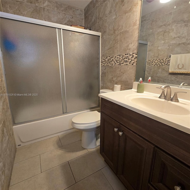 12900 SW 81st St, Kendall, FL 33183 - full bath with tile walls, tile patterned flooring, shower / bath combination with glass door, vanity, and toilet