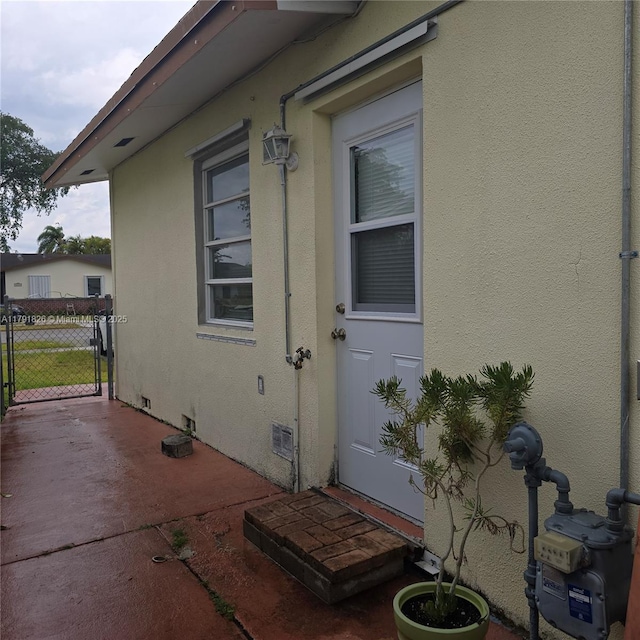 12900 SW 81st St, Kendall, FL 33183 - doorway to property with stucco siding, crawl space, and fence