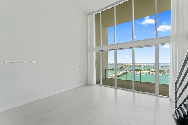 1040 Biscayne Blvd Unit 3802, Miami, FL 33132 - empty room with a water view, baseboards, and a high ceiling