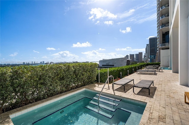 1040 Biscayne Blvd Unit 3802, Miami, FL 33132 - view of swimming pool featuring a skyline view, a hot tub, and a patio