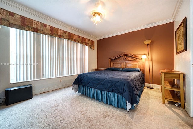 carpeted bedroom with crown molding and baseboards