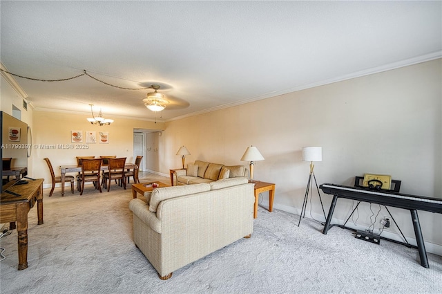 living room with crown molding, light carpet, a chandelier, and baseboards