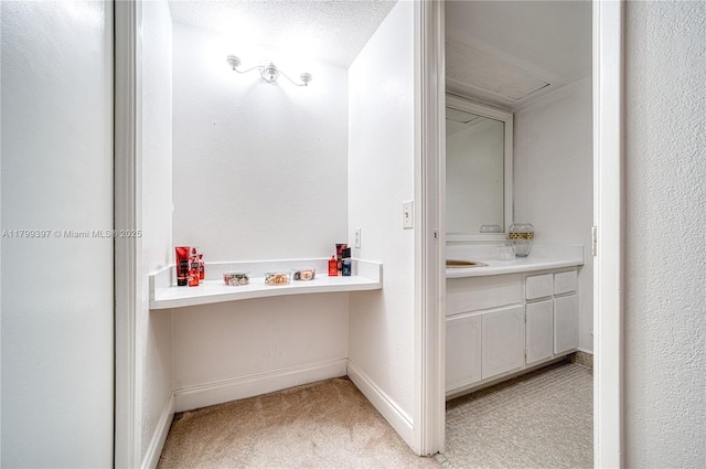 bathroom with vanity and baseboards