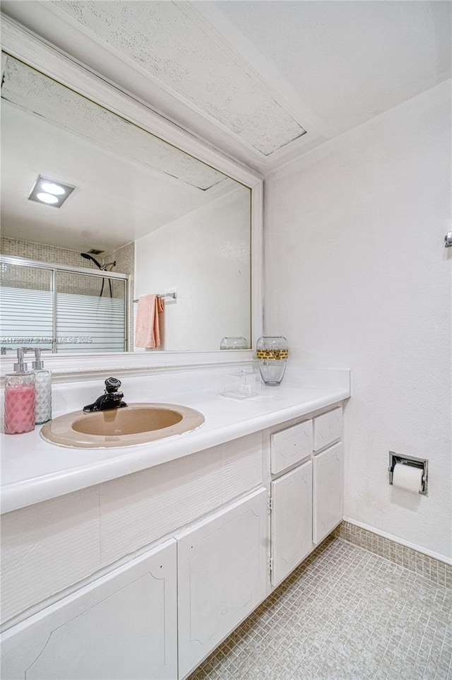 full bathroom with vanity, a shower stall, tile patterned flooring, and baseboards
