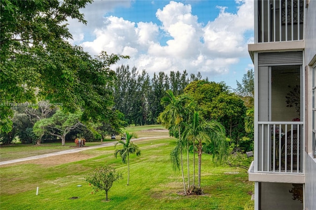 view of home's community with a yard and view of scattered trees