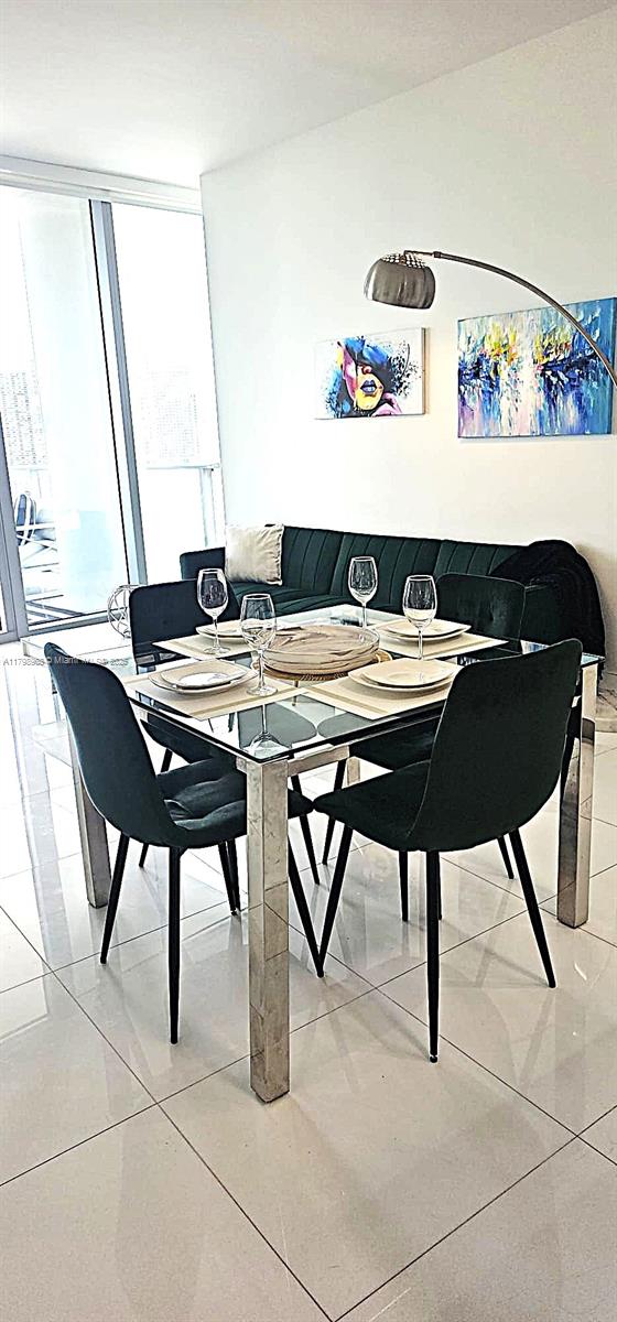 851 NE 1st Ave Unit 1700, Miami, FL 33132 - dining area with light tile patterned flooring and floor to ceiling windows