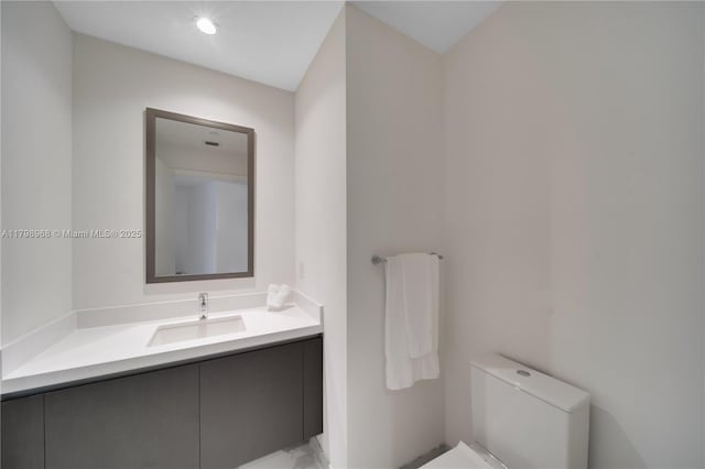half bathroom featuring toilet and vanity