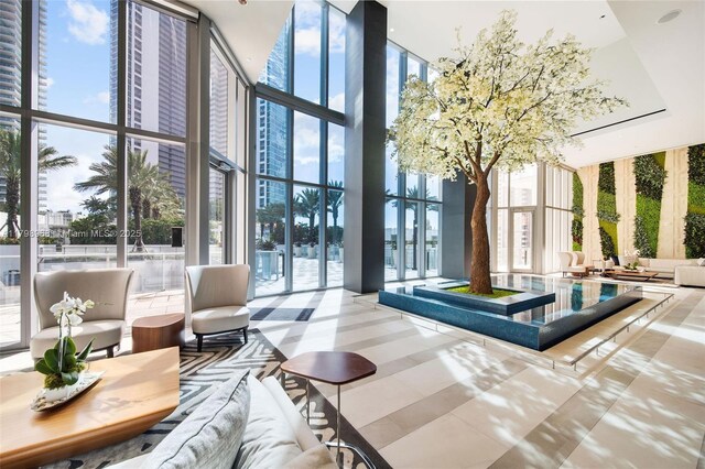 851 NE 1st Ave Unit 1700, Miami, FL 33132 - building lobby with expansive windows, a towering ceiling, and a water view