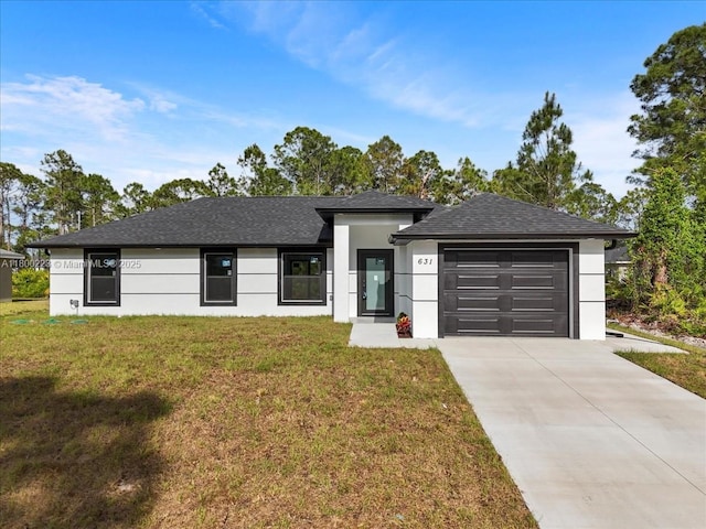 prairie-style house featuring a garage, concrete driveway, a front yard, stucco siding, and roof with shingles