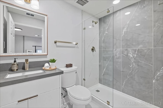 bathroom with a marble finish shower, toilet, and vanity