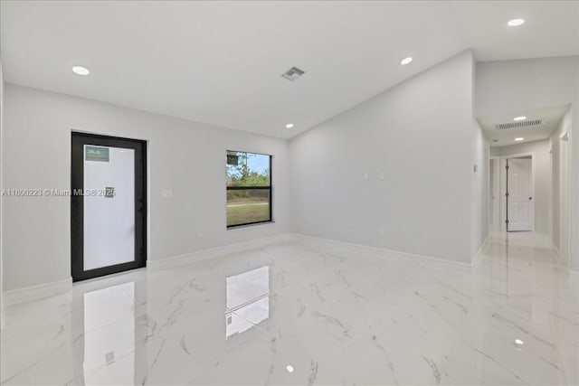 spare room featuring recessed lighting, baseboards, and light marble finish flooring
