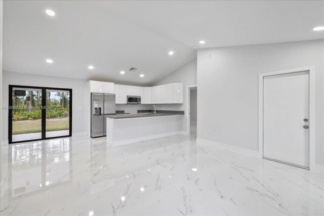 631 S Summit Ave, Lehigh Acres, FL 33974 - kitchen featuring stainless steel appliances, a sink, white cabinetry, dark countertops, and baseboards