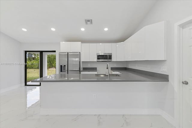 631 S Summit Ave, Lehigh Acres, FL 33974 - kitchen featuring appliances with stainless steel finishes, a sink, light marble finish floors, a peninsula, and white cabinets