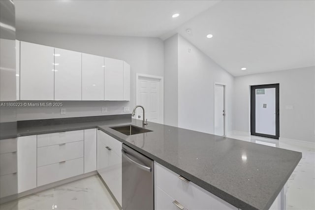 kitchen featuring vaulted ceiling, a sink, light marble finish floors, dishwasher, and modern cabinets