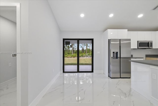 631 S Summit Ave, Lehigh Acres, FL 33974 - kitchen featuring appliances with stainless steel finishes, light marble finish flooring, white cabinets, baseboards, and recessed lighting