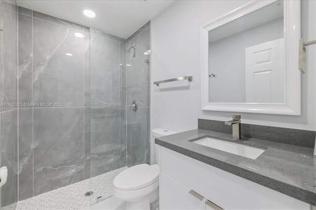 full bathroom featuring a stall shower, toilet, vanity, and recessed lighting