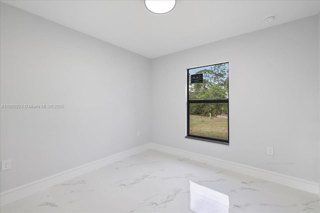 empty room with light marble finish floors and baseboards