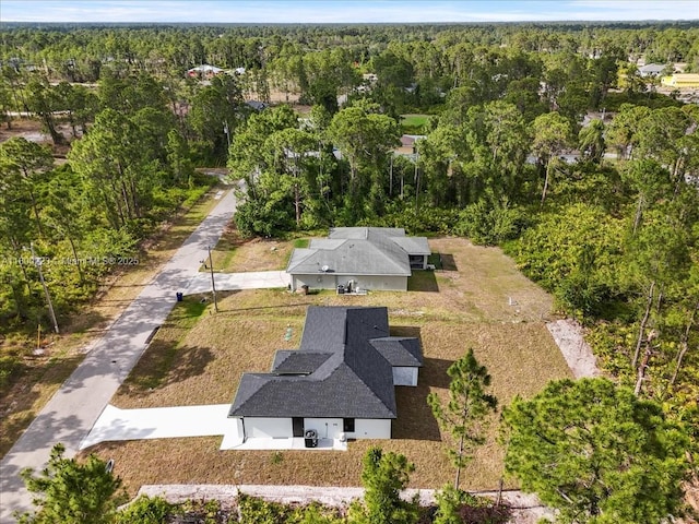 view of subject property with a heavily wooded area