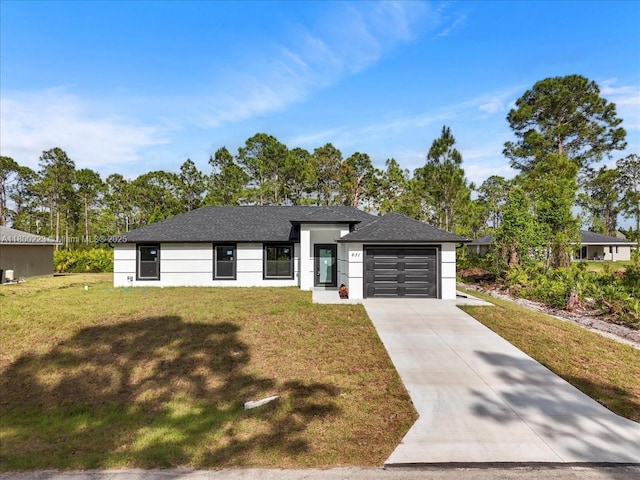 view of front of property with an attached garage, driveway, a front lawn, stucco siding, and roof with shingles