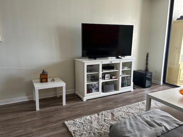 2851 Somerset Dr Unit 307, Lauderdale Lakes, FL 33311 - living room with baseboards and wood finished floors