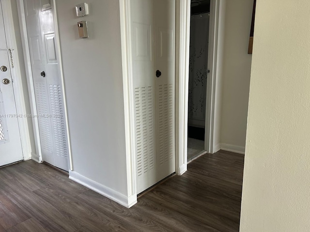 2851 Somerset Dr Unit 307, Lauderdale Lakes, FL 33311 - hall featuring dark wood-type flooring and baseboards