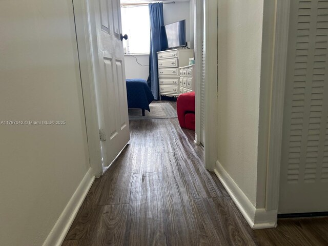 2851 Somerset Dr Unit 307, Lauderdale Lakes, FL 33311 - corridor featuring wood finished floors and baseboards