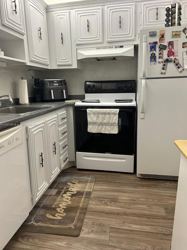 2851 Somerset Dr Unit 307, Lauderdale Lakes, FL 33311 - kitchen featuring white appliances, under cabinet range hood, a sink, dark wood finished floors, and tasteful backsplash
