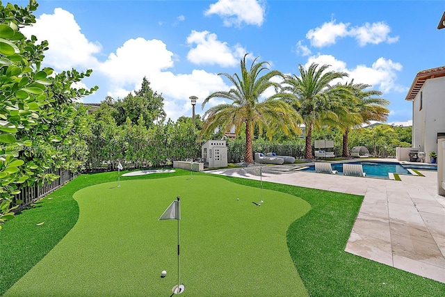 2069 Dickens Ter, Palm Beach Gardens, FL 33418 - view of home's community featuring a putting green, a fenced backyard, a patio, and a pool