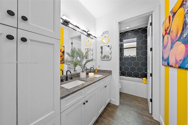 2069 Dickens Ter, Palm Beach Gardens, FL 33418 - full bathroom with toilet, wood finished floors, double vanity, and bathtub / shower combination