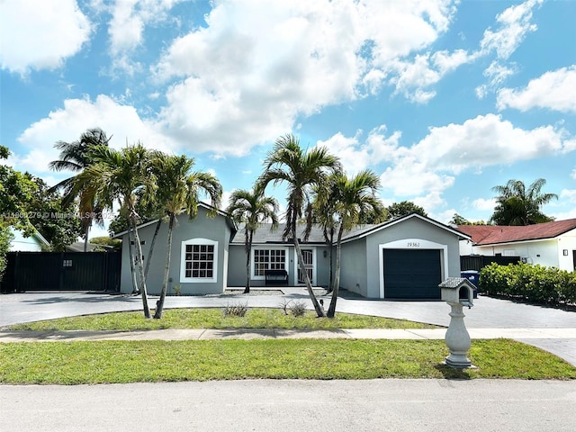 19361 NW 61st Ave, Hialeah, FL 33015 - ranch-style home with driveway, a garage, and stucco siding