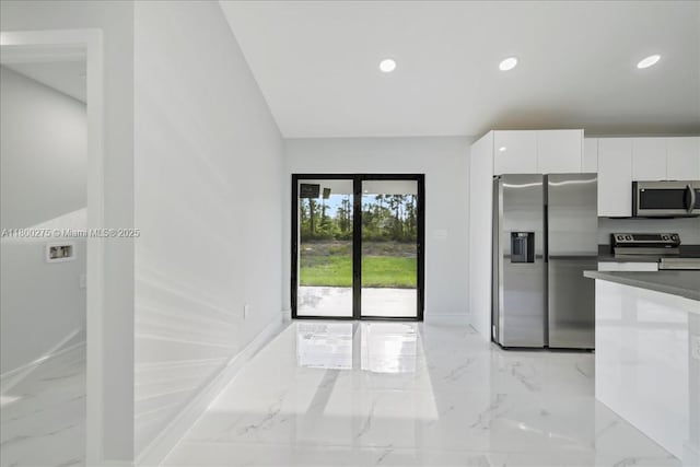 817 Moore Ave, Lehigh Acres, FL 33972 - kitchen with stainless steel appliances, white cabinets, light marble finish flooring, modern cabinets, and recessed lighting