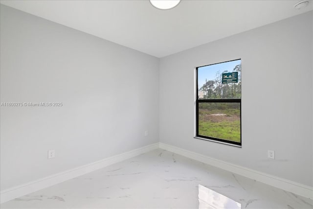 817 Moore Ave, Lehigh Acres, FL 33972 - unfurnished room featuring marble look tiles, baseboards, and a smoke detector