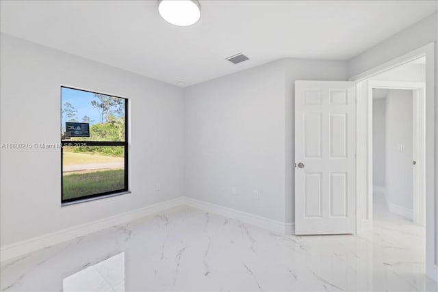 817 Moore Ave, Lehigh Acres, FL 33972 - unfurnished room with marble finish floors and baseboards