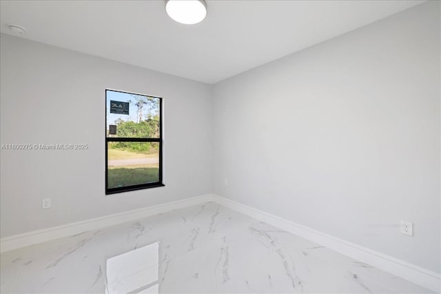 817 Moore Ave, Lehigh Acres, FL 33972 - unfurnished room with marble finish floors, baseboards, and a smoke detector