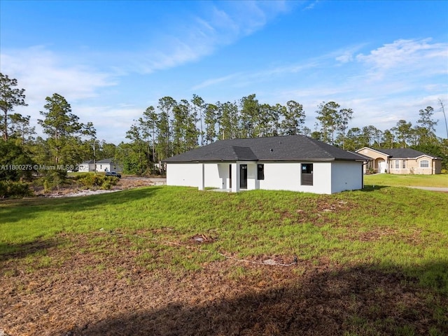 817 Moore Ave, Lehigh Acres, FL 33972 - back of property with a yard