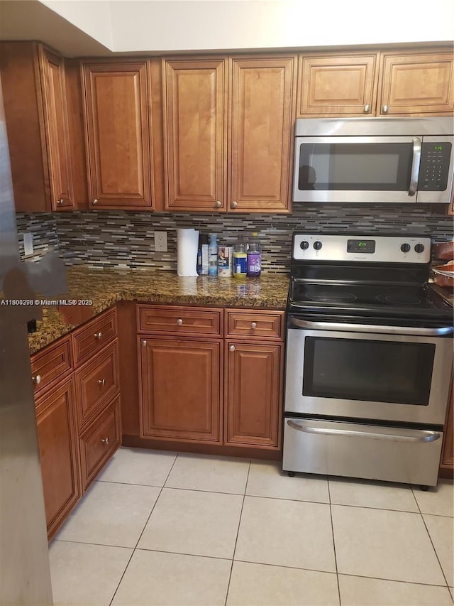 2520 Van Buren St Unit 7, Hollywood, FL 33020 - kitchen featuring stainless steel appliances, backsplash, and brown cabinetry