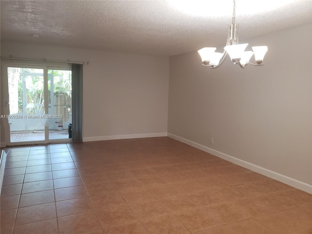 2520 Van Buren St Unit 7, Hollywood, FL 33020 - unfurnished room with a chandelier, a textured ceiling, light tile patterned floors, and baseboards