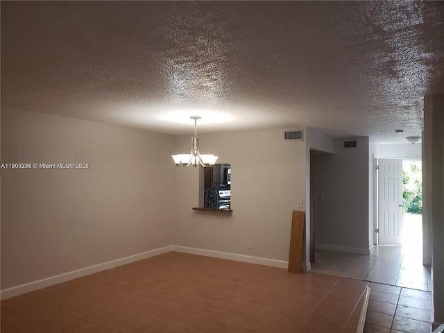 2520 Van Buren St Unit 7, Hollywood, FL 33020 - tiled empty room featuring a textured ceiling, a chandelier, and baseboards