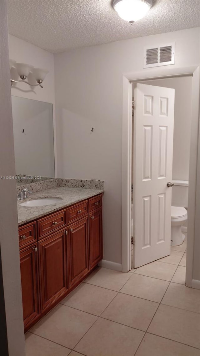 2520 Van Buren St Unit 7, Hollywood, FL 33020 - bathroom featuring tile patterned floors, vanity, a textured ceiling, and toilet