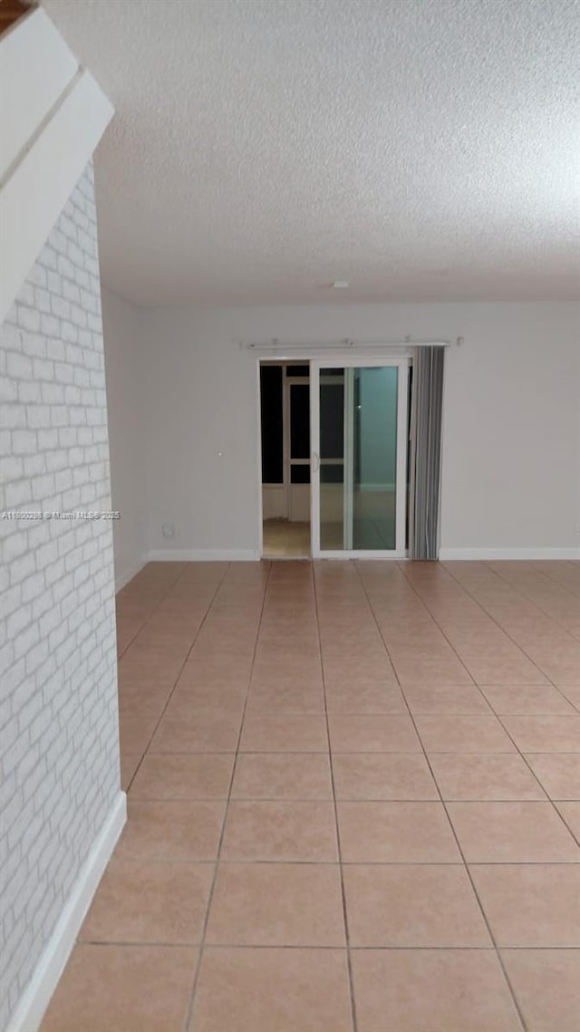 2520 Van Buren St Unit 7, Hollywood, FL 33020 - unfurnished room with a textured ceiling, light tile patterned floors, and baseboards