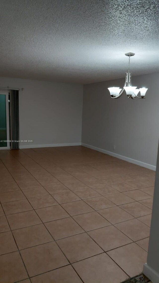 2520 Van Buren St Unit 7, Hollywood, FL 33020 - unfurnished room featuring a textured ceiling, a chandelier, and baseboards