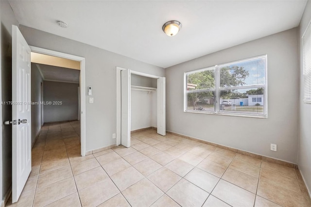 5720 SW 40th Ct, West Park, FL 33023 - unfurnished bedroom featuring light tile patterned floors, a closet, and baseboards
