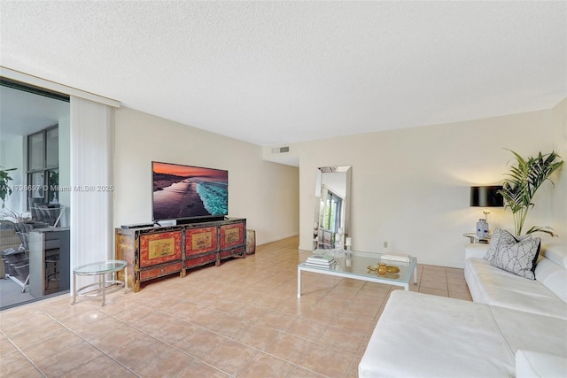 living room with tile patterned floors and a textured ceiling