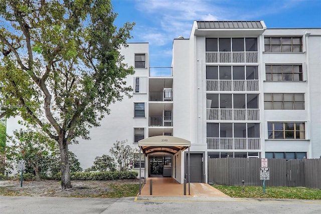 view of apartment building / complex featuring fence