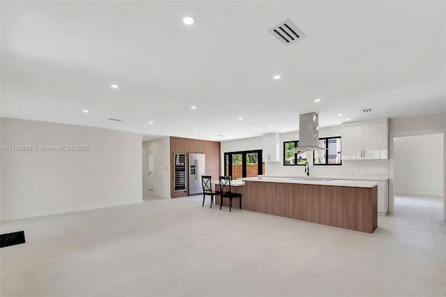 9494 SW 144th St, Miami, FL 33176 - kitchen with island range hood, modern cabinets, light countertops, white cabinetry, and recessed lighting