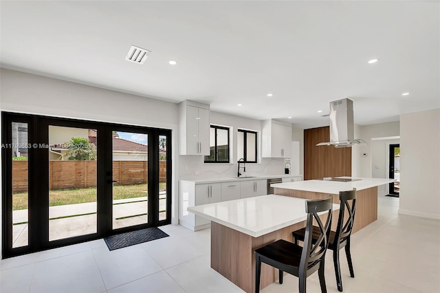 9494 SW 144th St, Miami, FL 33176 - kitchen featuring modern cabinets, extractor fan, a kitchen island, light countertops, and white cabinets