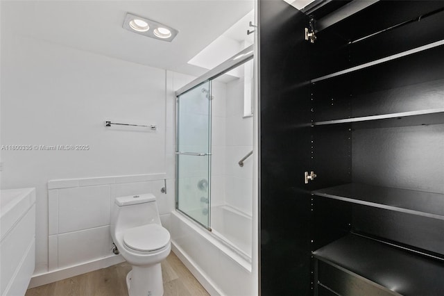 6900 Bay Dr Unit 10I, Miami Beach, FL 33141 - full bathroom with wood finished floors, toilet, and enclosed tub / shower combo