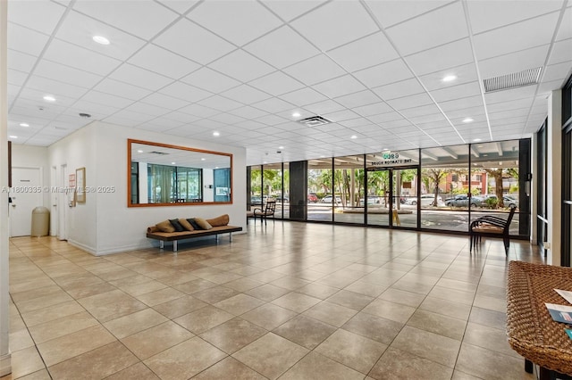 6900 Bay Dr Unit 10I, Miami Beach, FL 33141 - building lobby featuring floor to ceiling windows, a drop ceiling, and recessed lighting