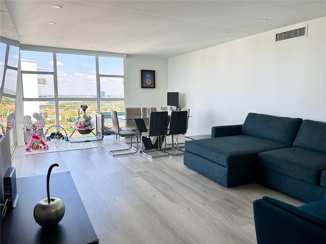 3731 N Country Club Dr Unit 2228, Aventura, FL 33180 - living room featuring light wood-style floors, a wall of windows, and recessed lighting